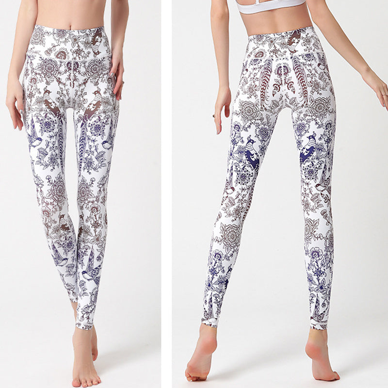 White leggings with a colorful floral pattern worn by a person on a white background