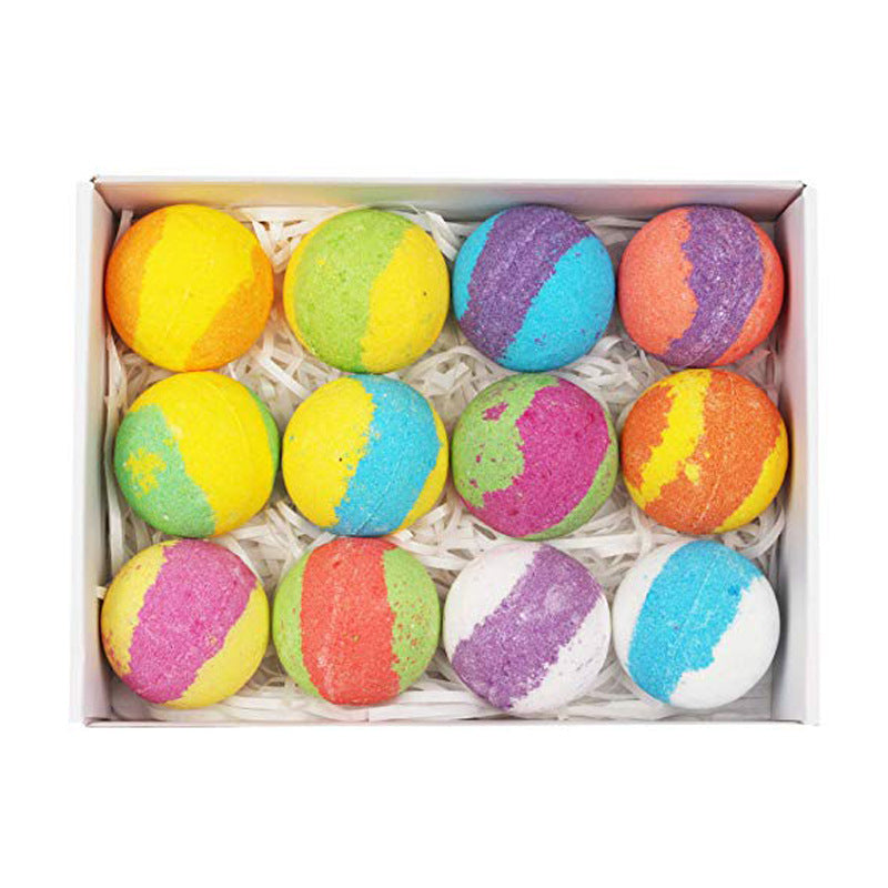 Box of colorful bath bombs on a white background