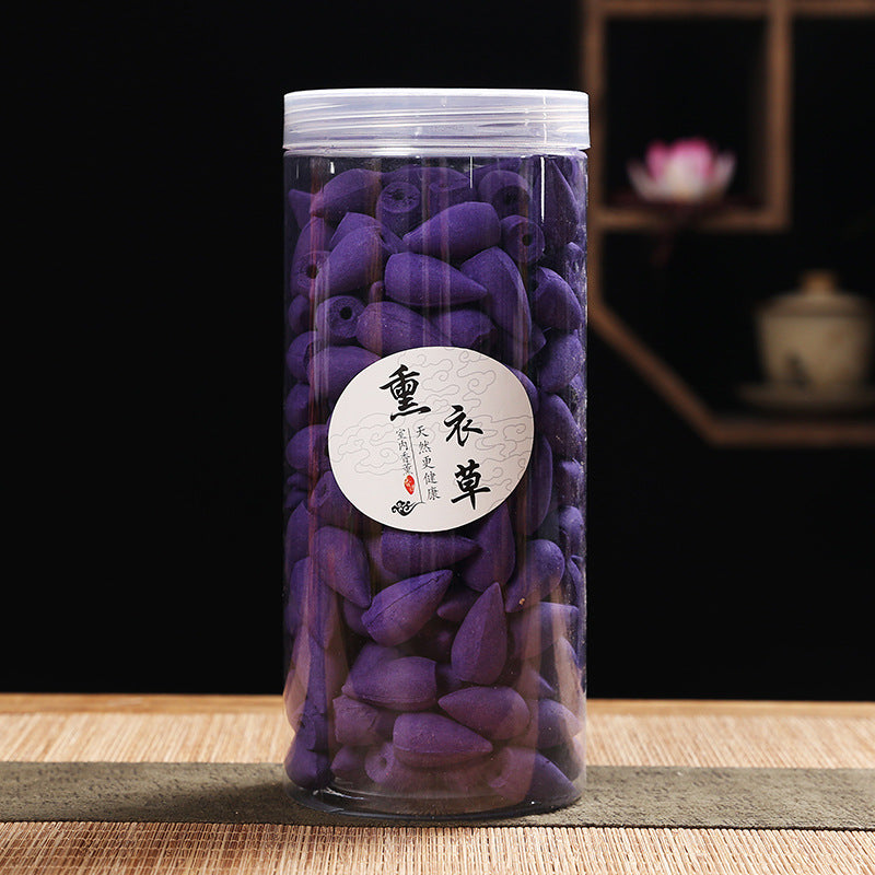 Clear jar filled with green tea cones on a wooden surface with a blurred background