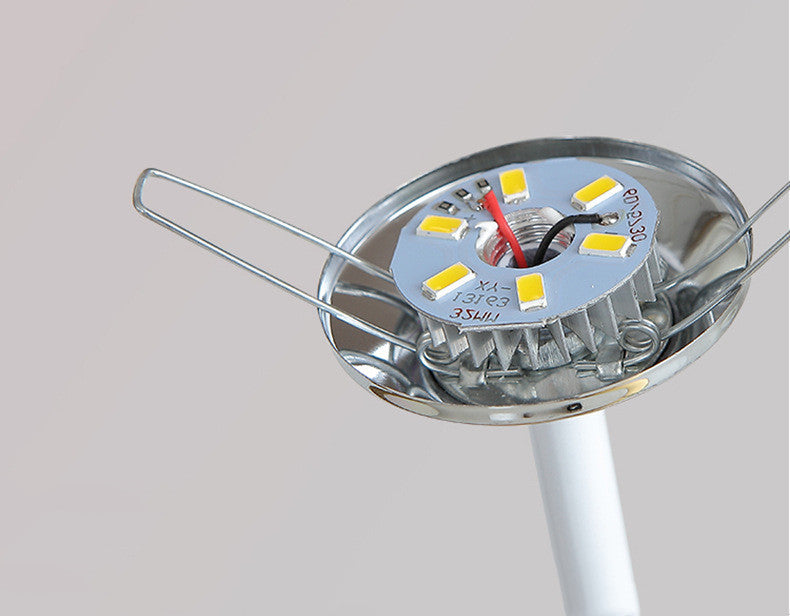 Close-up of a metallic object with LED lights on a gray background