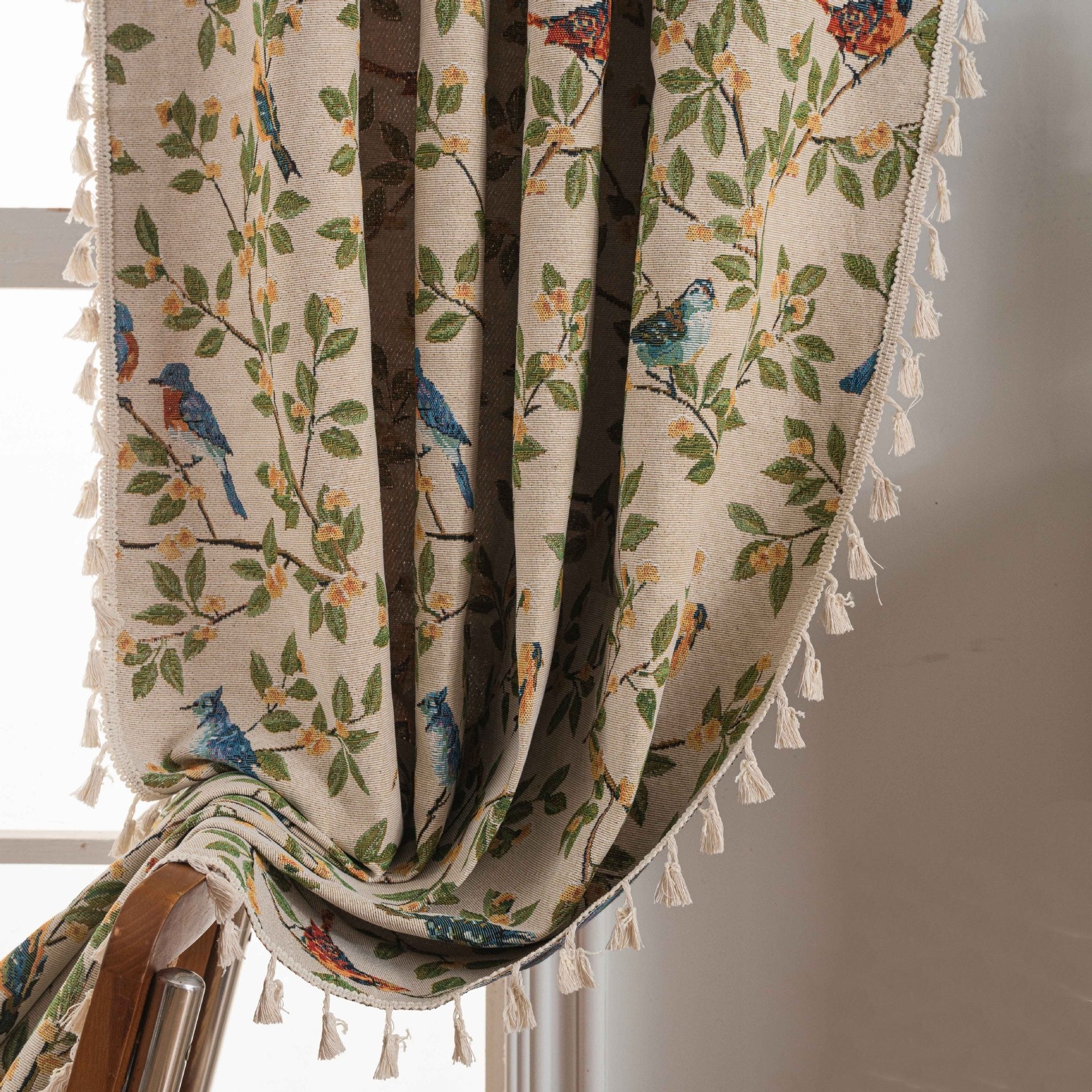 Decorative curtain with floral and bird pattern and tassels