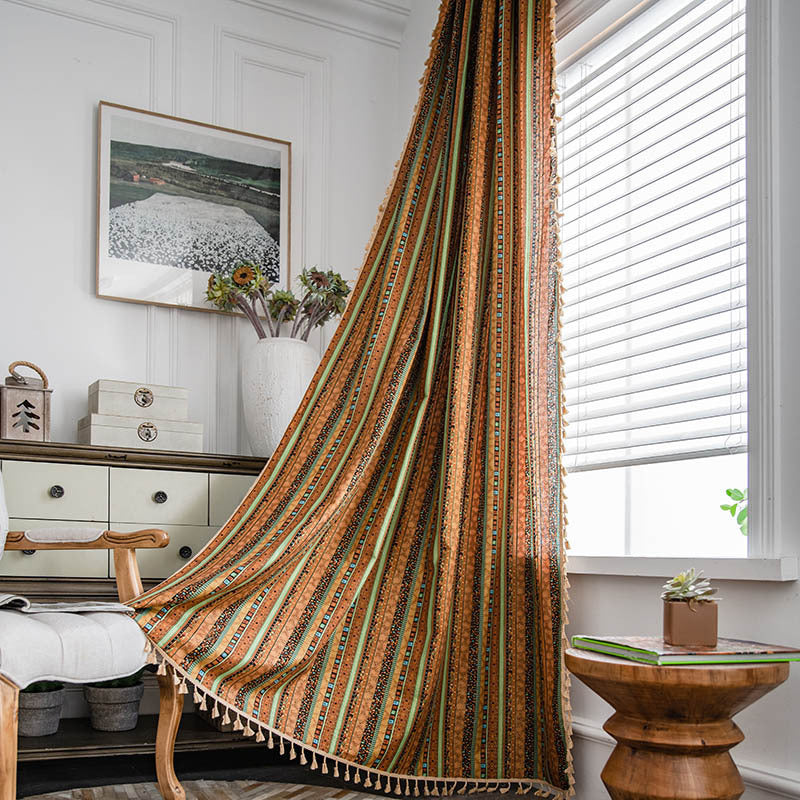 Striped curtain hanging in a room with a window, furniture, and decor.