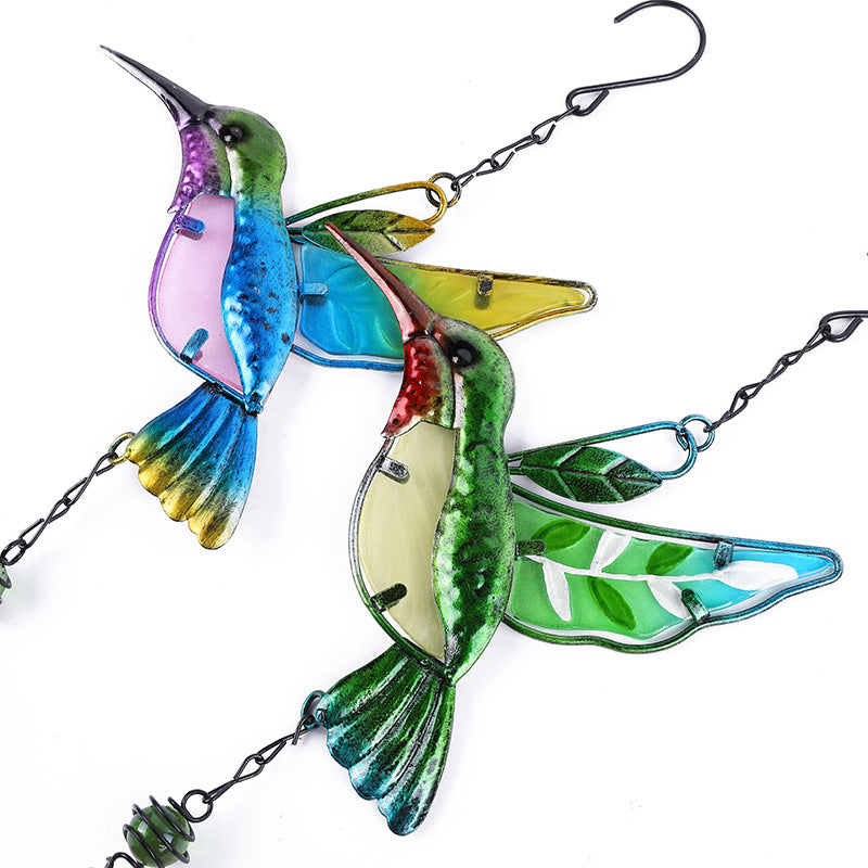 Colorful stained glass hummingbird hanging decoration on a white background