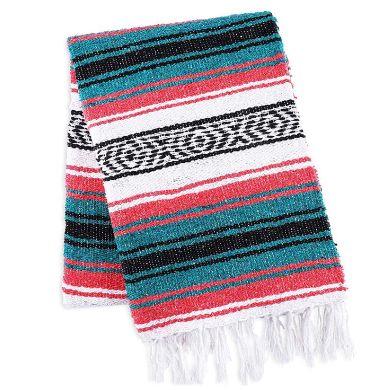 Colorful striped blanket with fringes on a white background