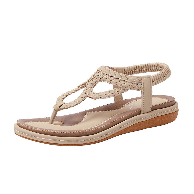 Beige sandal with braided design on a white background
