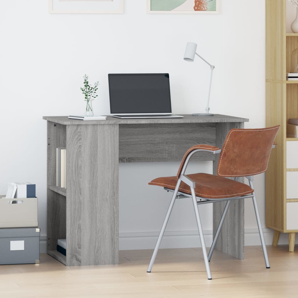 Gray wooden desk with a laptop and lamp, brown chair, and storage boxes in a room.