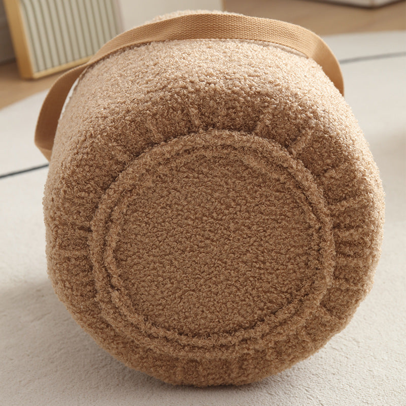 Round brown cushion with a textured pattern on a light-colored floor.