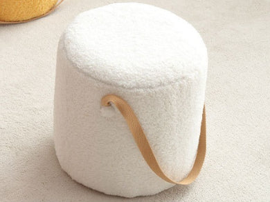 White ottoman with a wooden handle on a light beige background