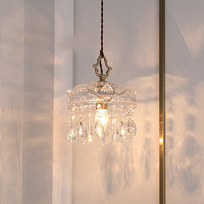 Crystal pendant light hanging against a neutral background
