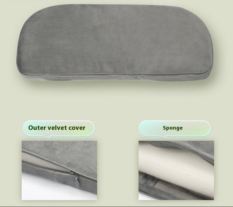 Gray pillow with outer velvet cover and sponge interior on a beige background