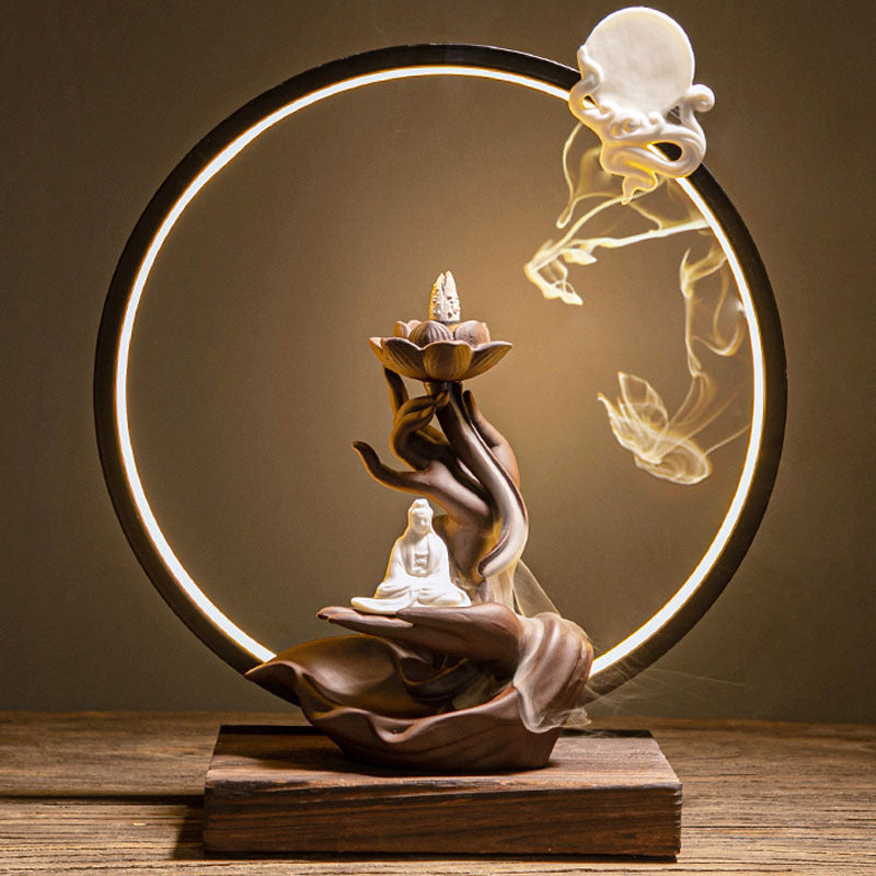 Decorative lamp with Buddha figure and circular light design on a wooden base.