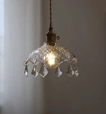 Decorative pendant light with crystal accents on a plain background