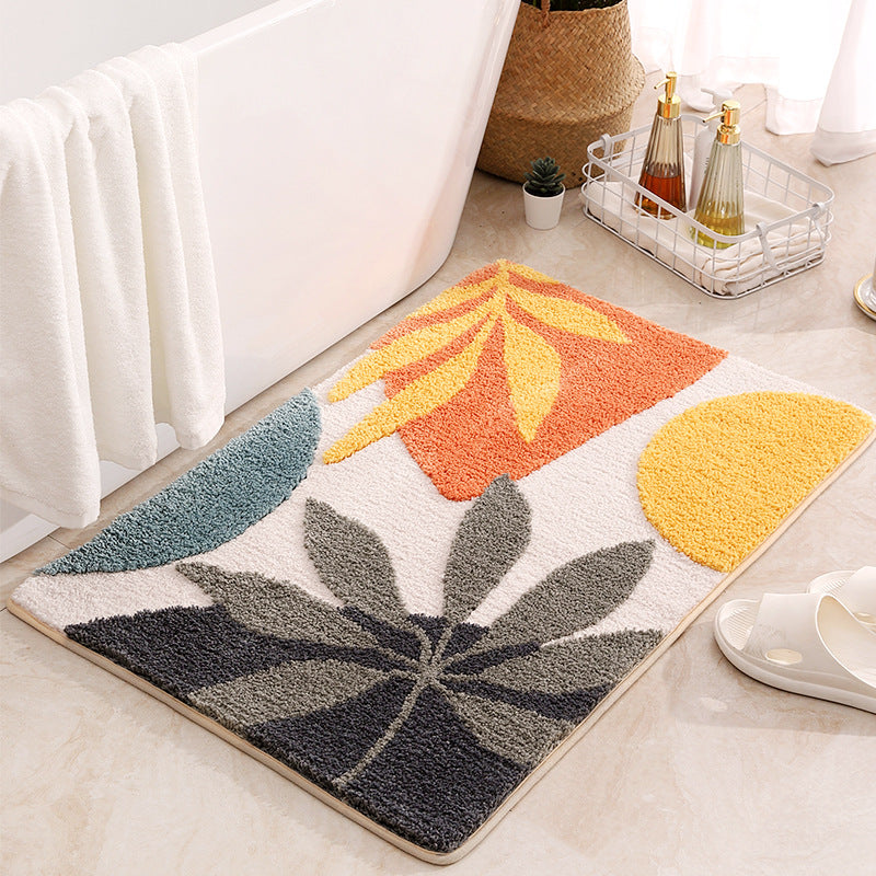 Decorative rug with leaf patterns on a light-colored floor.