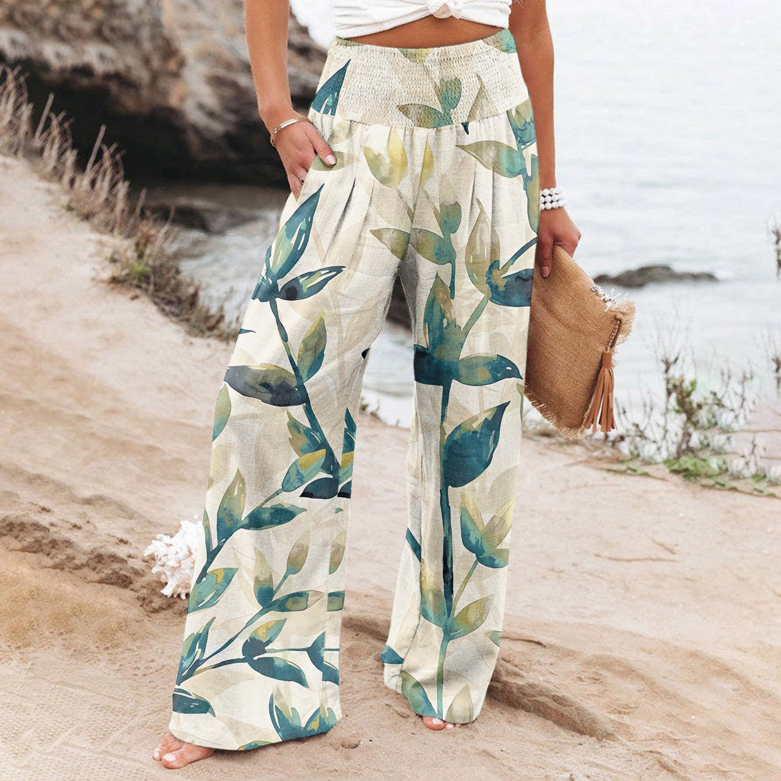 Person wearing floral-patterned pants on a beach