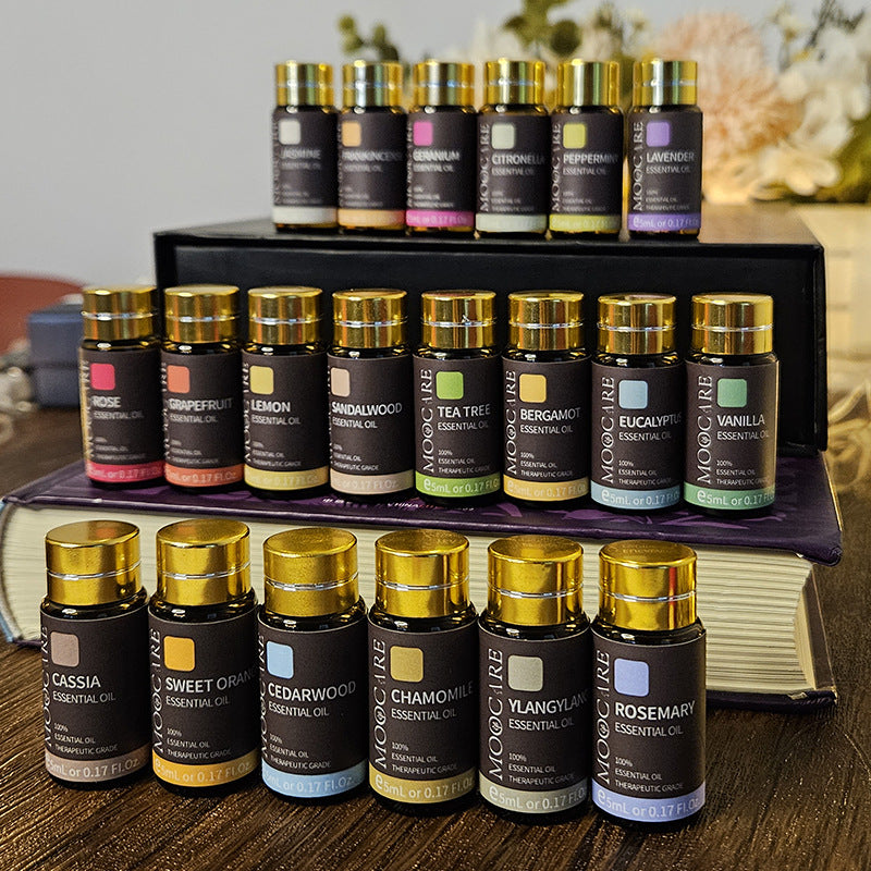 Collection of essential oil bottles on a wooden surface with a blurred background