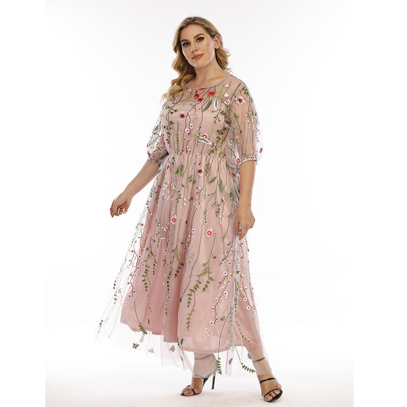Woman wearing a pink floral dress on a white background
