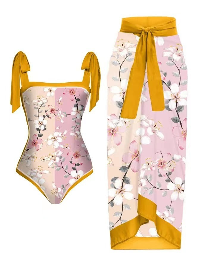 Floral swimsuit with matching sarong on a white background
