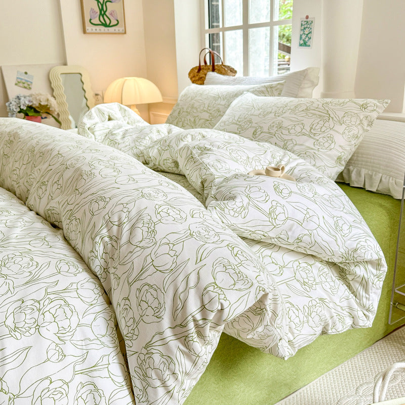 Floral patterned bed set on a bed in a bright bedroom.Floral bedding set on a bed in a bright bedroom