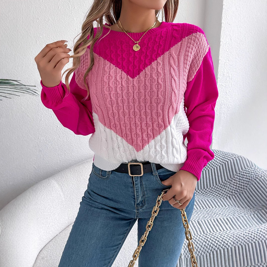 Person wearing a pink and white sweater with blue jeans, sitting on a white couch.