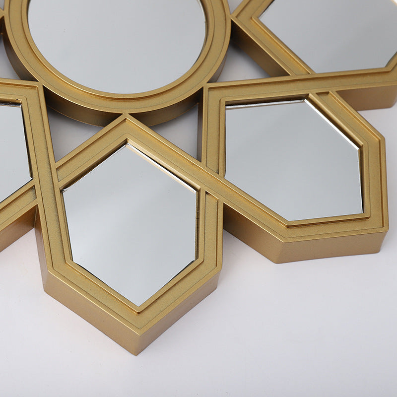 Gold geometric mirror wall art on a white background