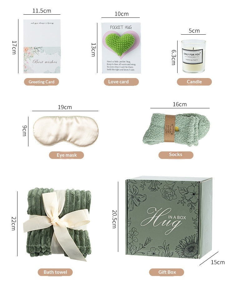 Gifting set with blanket, mug, candle, and small plant on a neutral background