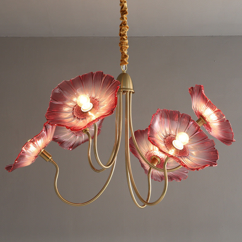 Chandelier with pink floral lampshades on a plain background