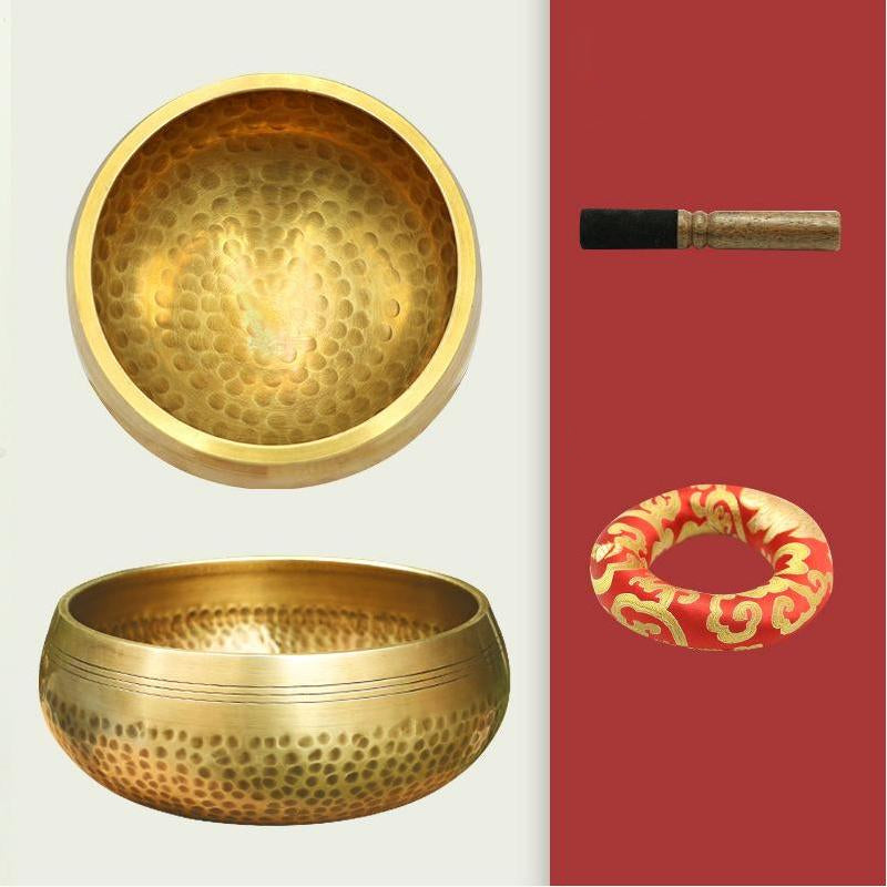 Two brass bowls and accessories on a white and red background
