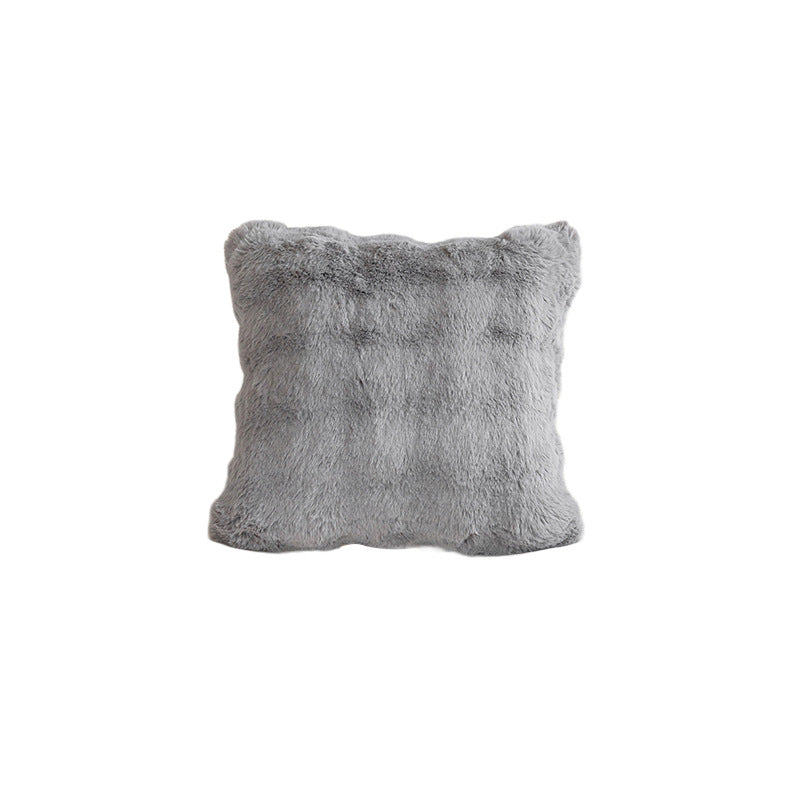 Gray fluffy pillow on a white background