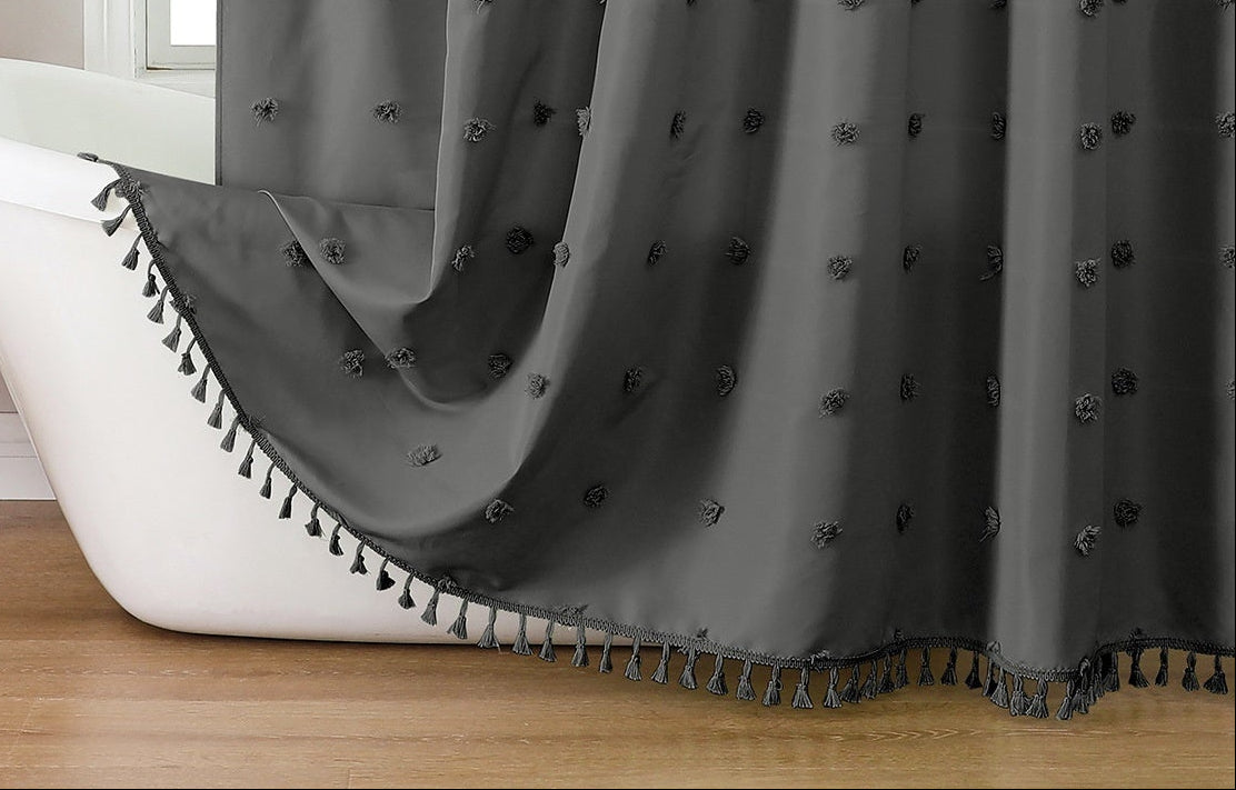 Gray shower curtain with decorative elements in a bathroom setting