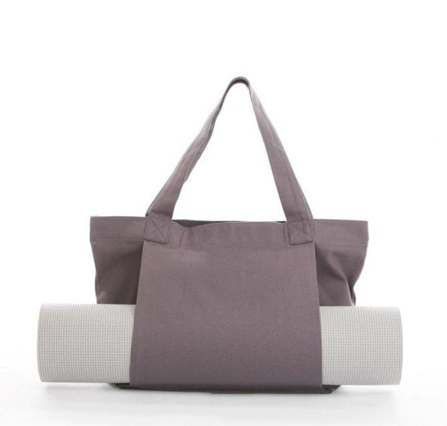 Gray tote bag with a yoga mat on a white background