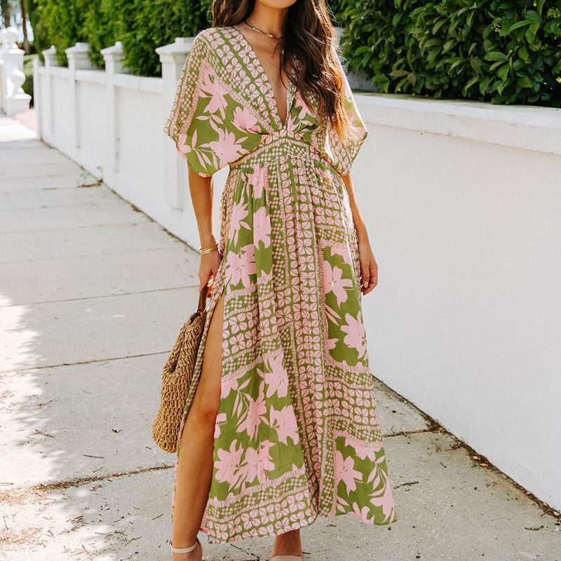 Woman wearing a floral dress with a white fence and greenery in the background