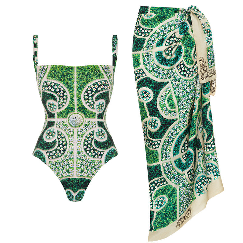 Green and white patterned swimsuit with matching sarong on a white background