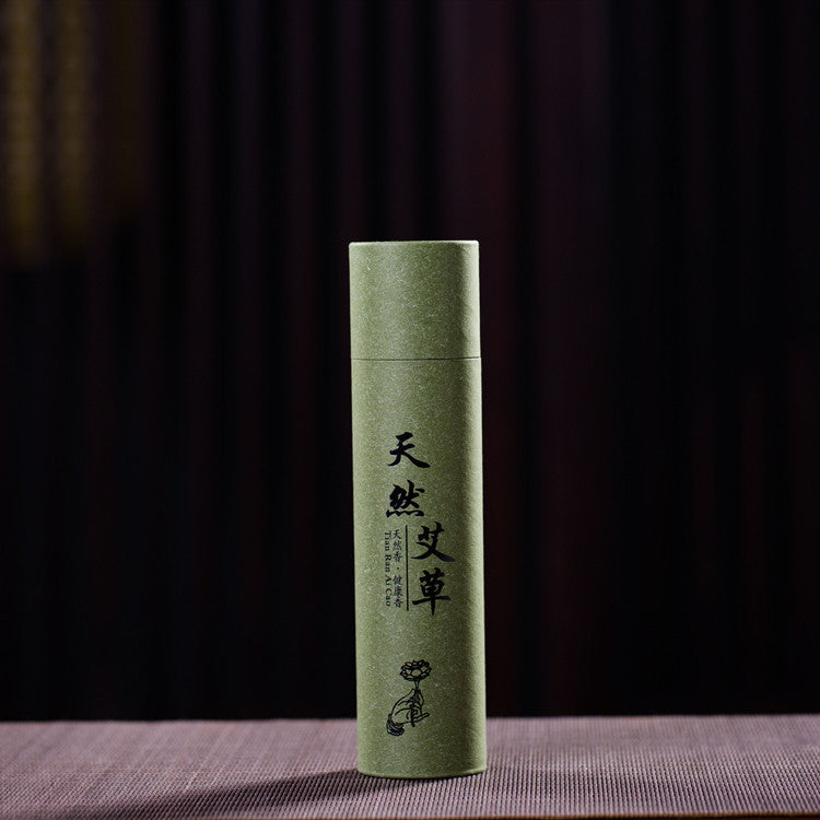 Green cylindrical container with text and a small illustration on a dark background