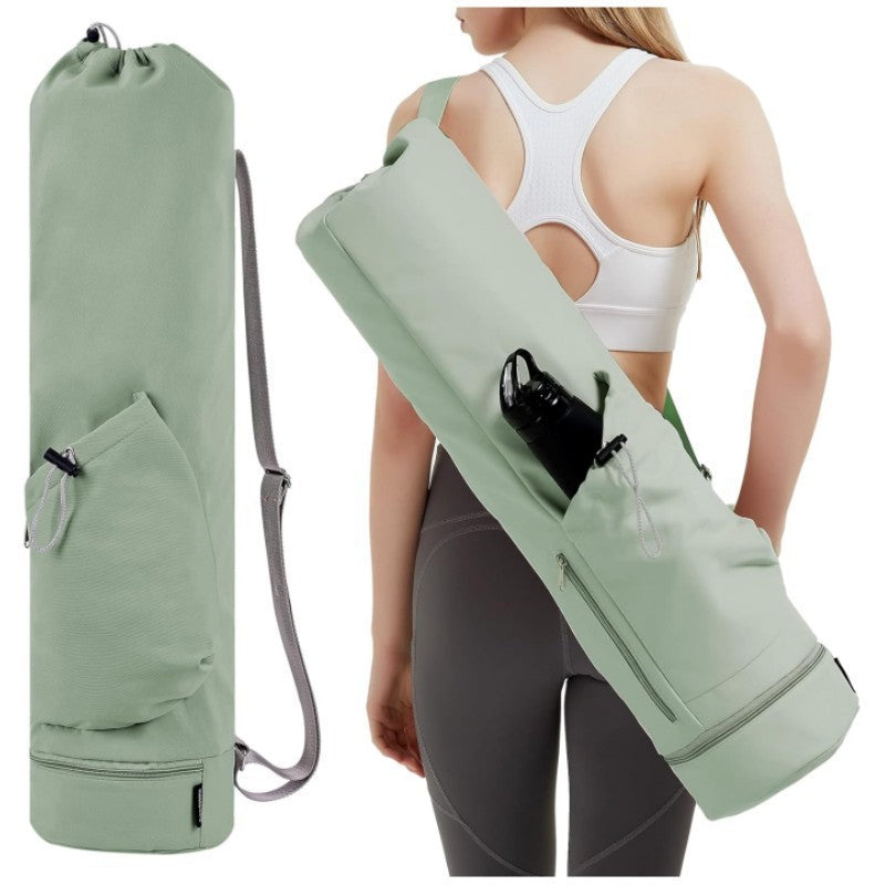 Green yoga mat bag with a drawstring and water bottle holder, shown on a person wearing athletic wear.