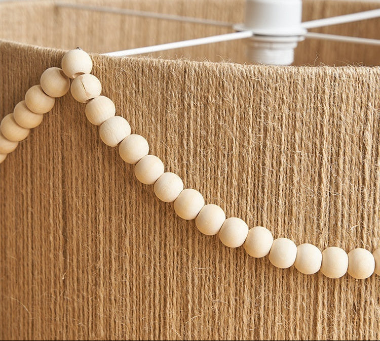 Hemp rope lampshade with wooden beads and text about material properties.