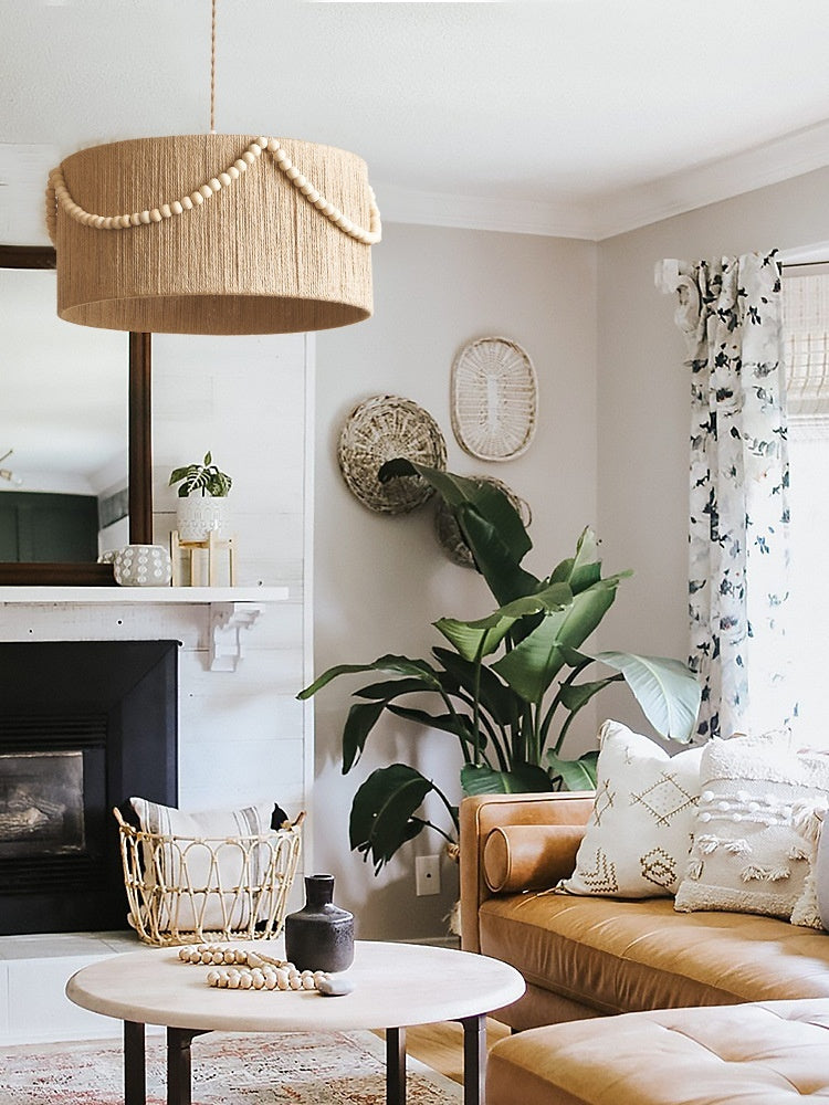 Living room with brown sofa, round coffee table, and decorative elements.