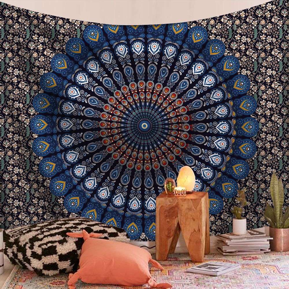 Decorative tapestry with mandala design in a room with a wooden table and pillows.