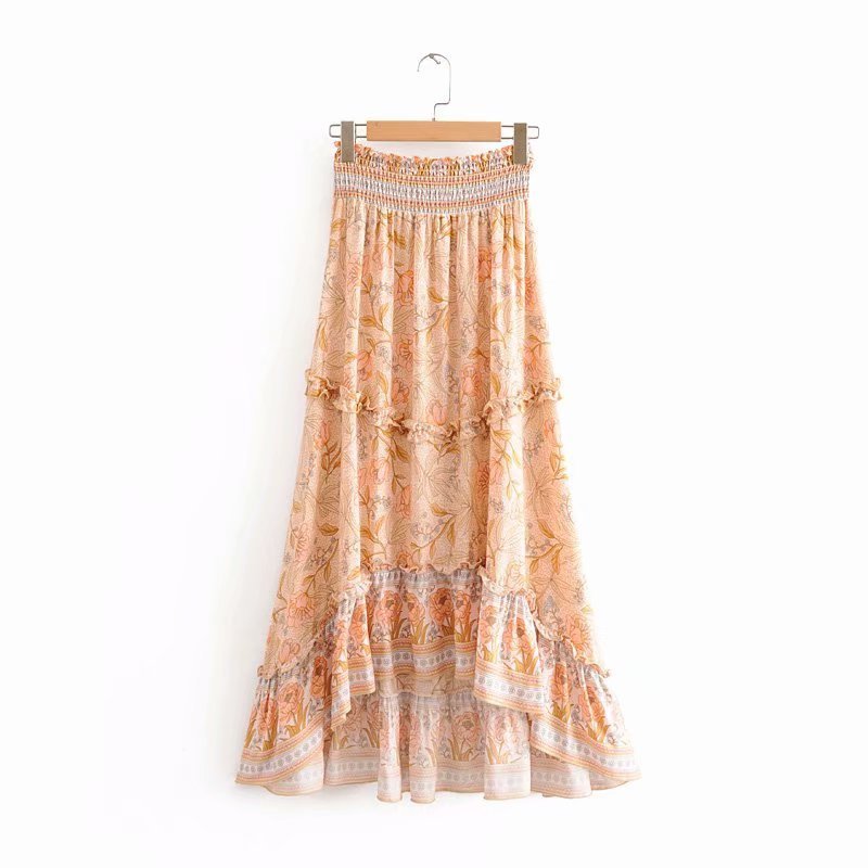Long patterned skirt on a hanger against a white background