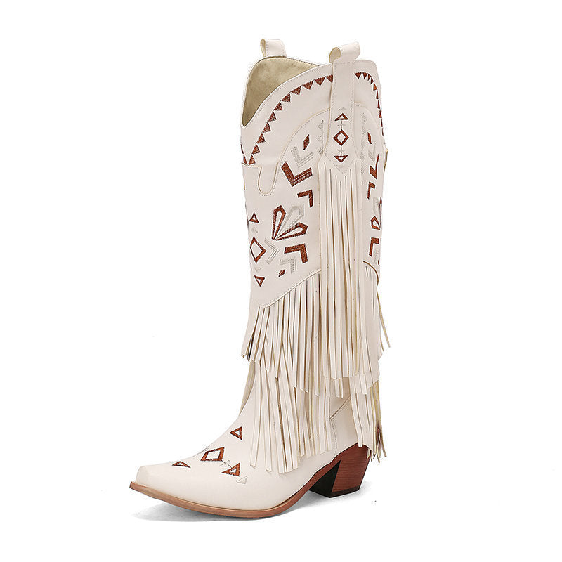 White cowboy boot with fringe and geometric patterns on a white background