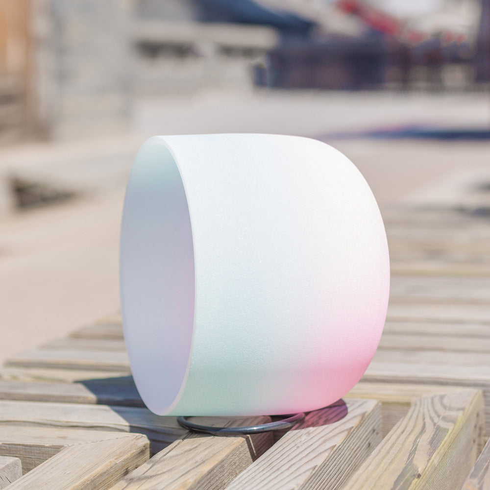 Round, gradient-colored Large Blue and Pink Crystal Meditation Bowls on a wooden surface with blurred background