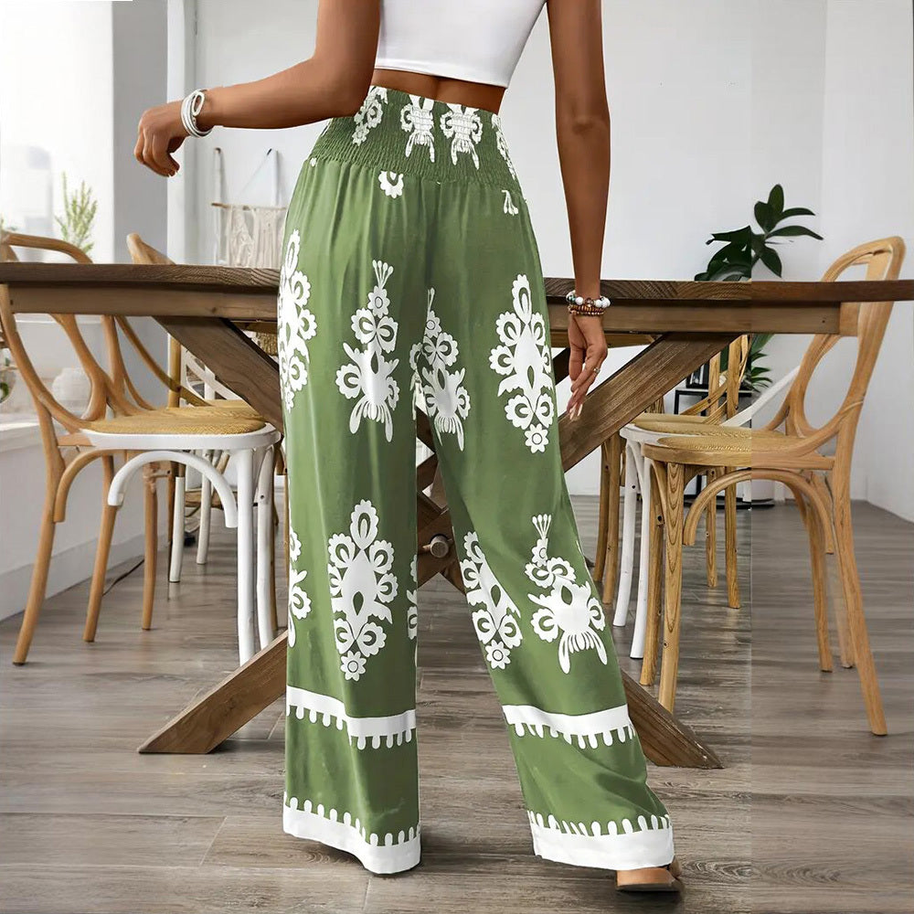 Person wearing green patterned pants in a dining room setting