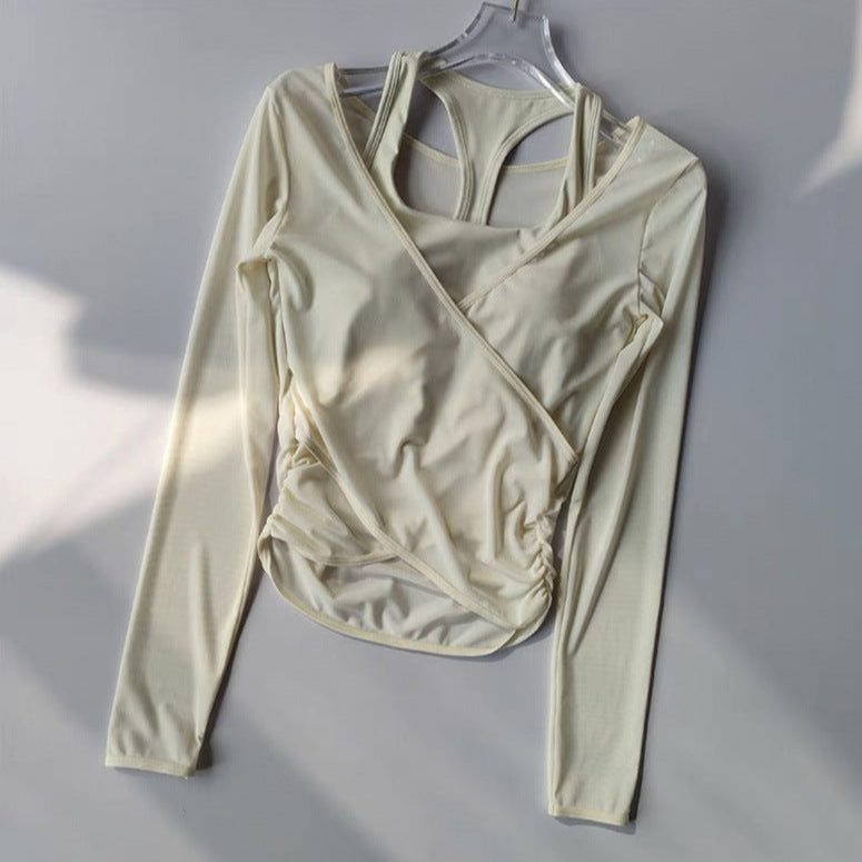 Beige long-sleeve top on a hanger against a gray background