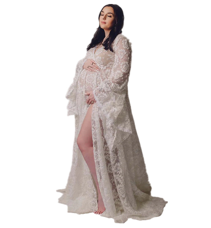 Pregnant woman wearing a white lace dress on a white background