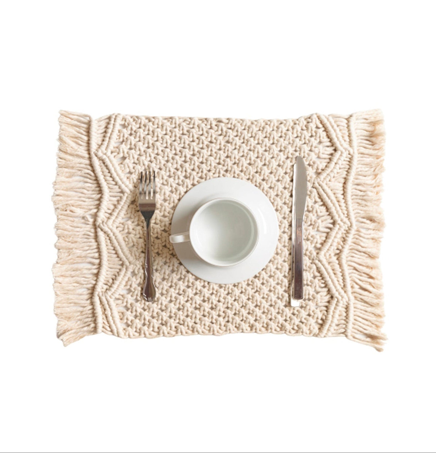 Beige woven placemat with a white cup, saucer, and cutlery on a white background