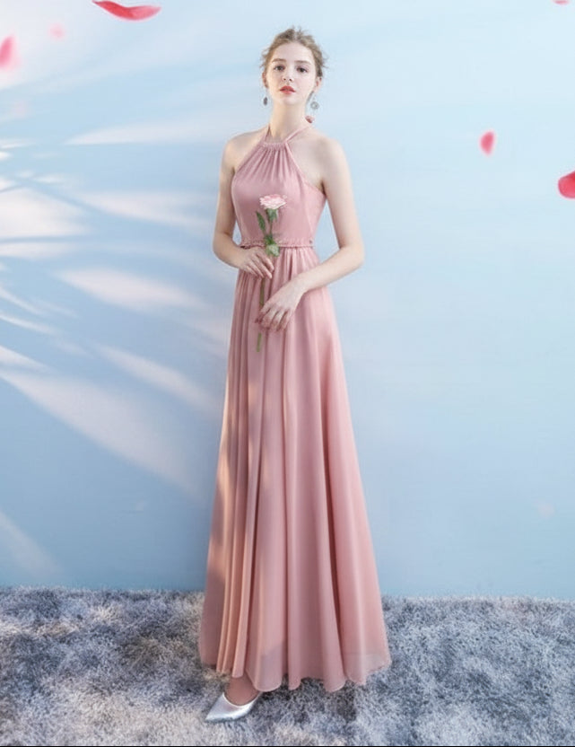 Woman in a long pink dress holding a rose against a light blue background with red flower petals.