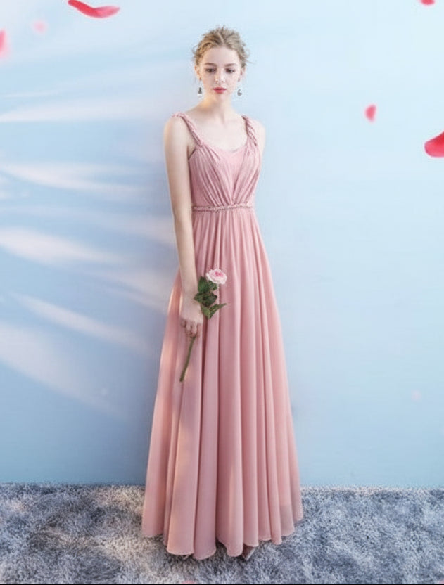 Woman in a pink dress against a light blue background with red flower petals.