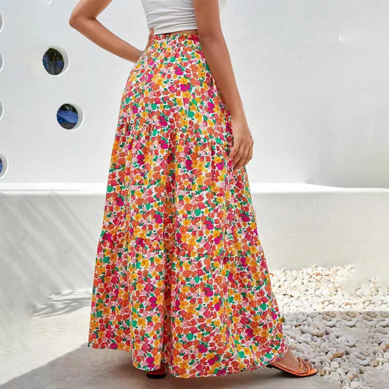 Person wearing a colorful floral skirt with a white background