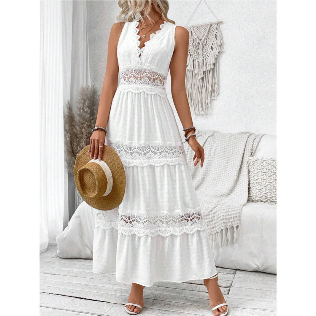Woman wearing a white lace dress with a straw hat in a bright room.
