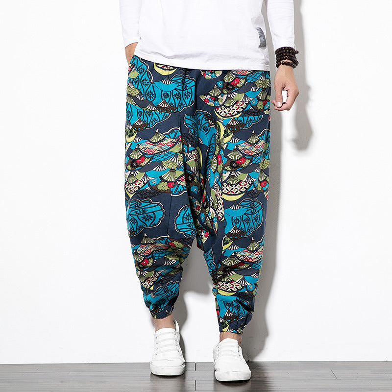 Person wearing colorful patterned pants on a white background