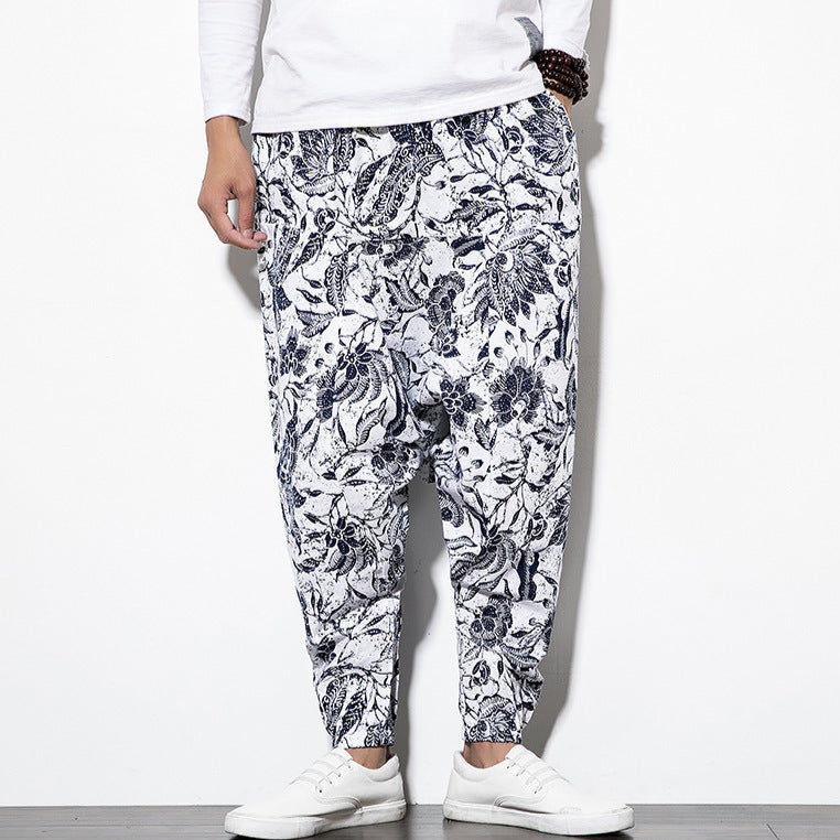 Person wearing floral-patterned pants on a white background
